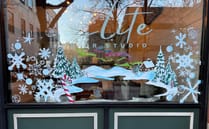 Holiday scene painted on the Elite Hair Studio window