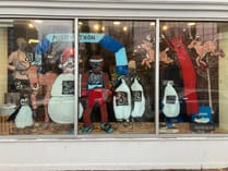 Merry-thon runners and reindeer painted on the Marathon Sports window