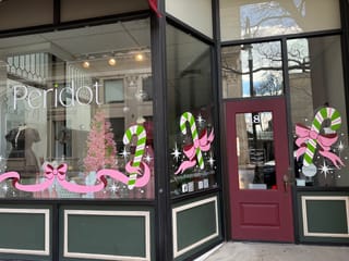 Candy canes and bows painted on the Peridot Boutique storefront