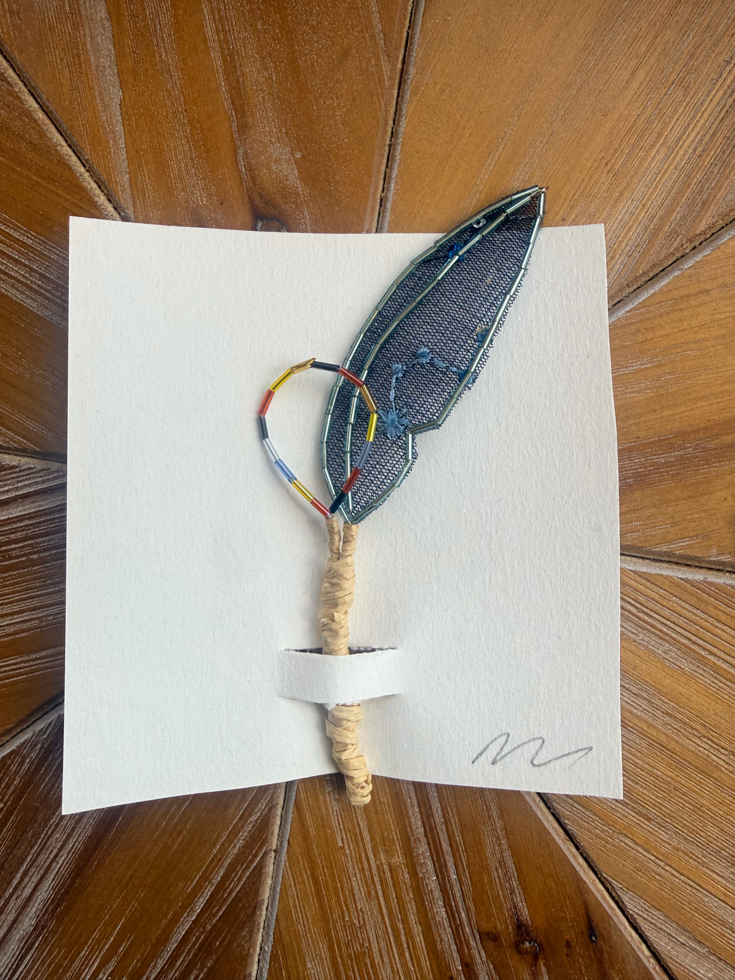 Small blue feather pick